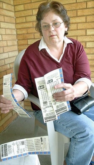 Patricia Moore, 59, is being sued by her husband, Gerald Moore, 81, for allegedly stealing a winning lottery ticket. Patricia Moore is also facing criminal charges. She is seen holding lottery tickets for upcoming draws.