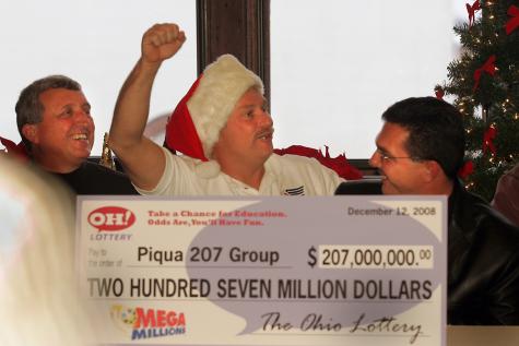 Richard Donnelly (from left), Loyal Davis and Arthur Rudy celebrate their winnings during a press conference at Fort Piqua Plaza on Wednesday, Dec. 17. Davis was the one who purchased the winning ticket. Fourteen employees of the city of Piqua and one relative of a city worker claimed the $207 million Mega Millions jackpot.